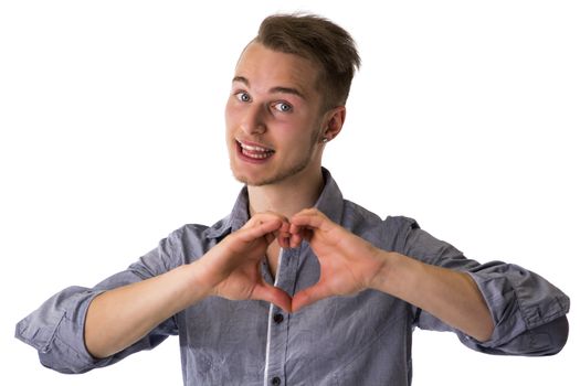 Happy blond young man doing heart or love sign with hands isolated on white