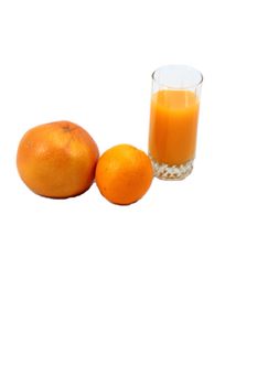 On white background whole grapefruit and orange and glass of orange juice