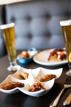 Traditional Portuguese Food and Blonde Draft Beer on a Table in a Restaurant