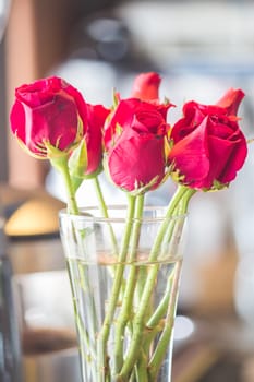 Red roses bouquet in vase, stock photo