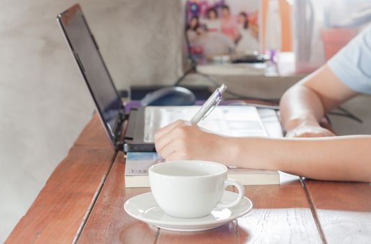 Woman working in coffee shop, stock photo