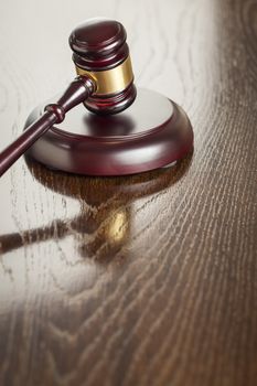 Dark Wooden Gavel Abstract on Reflective Table with Room for Text.