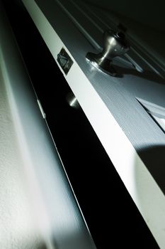 Door leading into darkness with a dramatic high contrast lighting
