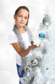 Girl dresses up Christmas tree