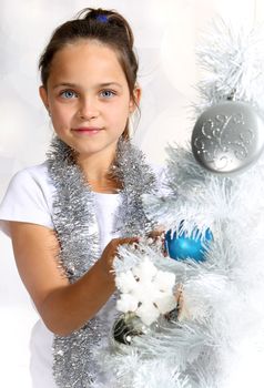 Girl dresses up Christmas tree