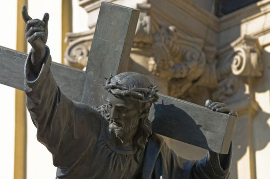 Sculpture of Jesus Christ carrying the Cross (1858) in front of the main entrance to the Church of the Holly Cross, Warsaw, Poland.