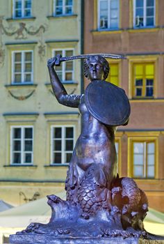The most famous Warsaw Mermaid - a 19th century sculpture by Konstanty Hegel - in the centre of the Old Town Market Square, Warsaw, Poland. A half-fish, half-woman with a sword and a shield in her hands is a symbol of the capital city.