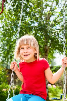 Little girl having fun playing in a summer park