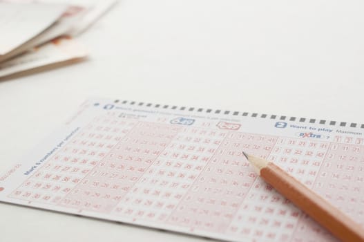 Coquitlam BC Canada - May 31, 2014 : Close up pen on lottery ticket. The British Columbia Lottery Corporation has  provided government sanctioned lottery games in British Columbia since 1985. 