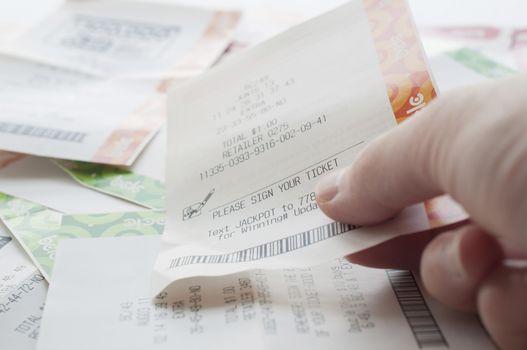 Coquitlam BC Canada - May 31, 2014 : Close up people holding a winning lottery ticket. The British Columbia Lottery Corporation has provided government sanctioned lottery games in British Columbia since 1985. 