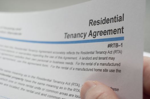 Close up woman reading residential tenancy agreement