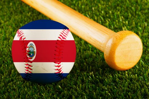 Baseball with Costa Rica flag and bat over a background of green grass