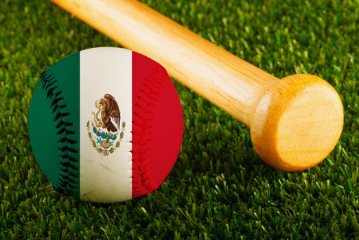 Baseball with Mexico flag and bat over a background of green grass