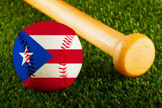 Baseball with Puerto Rico flag and bat over a background of green grass