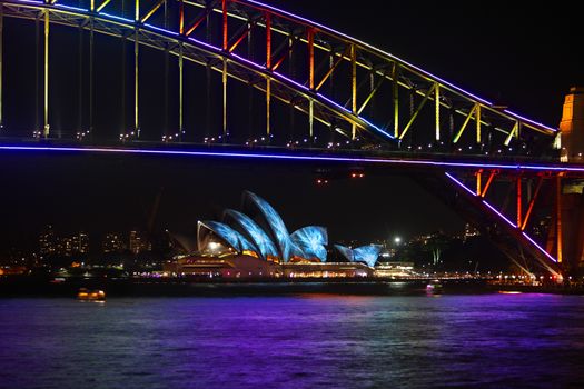 NTH SYDNEY, AUSTRALIA - JUNE 7, 2014; Sydney Harbour Bridge and Opera Hopuse in vibrant colours during Vivid Sydney annual festival celebrations, Sydney Australia