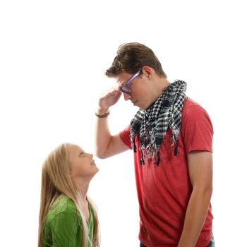 a teen boy talking with a young blond girl