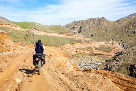 Cycle tourist on a dirt road in Pontic Mountains of Northern Turkey