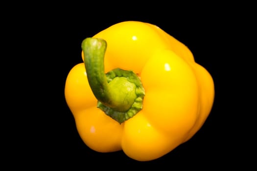 Photo of yellow raw pepper on black background