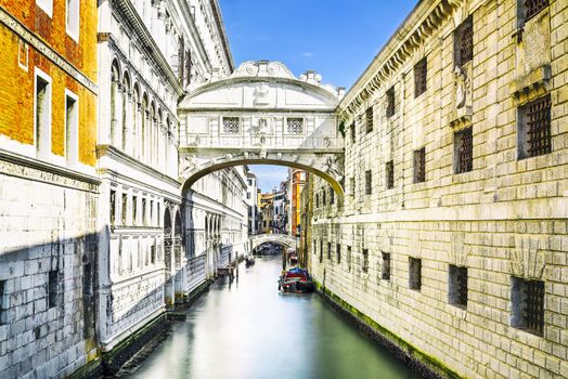 Gondolas passing under the Bridge of Sighs - Ponte dei Sospiri. A legend says that lovers will be granted eternal love if they kiss on a gondola at sunset under the Bridge. Venice, Italy, Europe. 