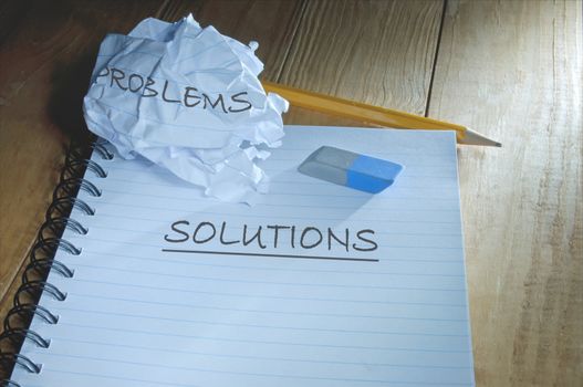 Discarded piece of paper with problems next to a fresh sheet with solutions
