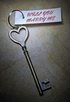 Marriage proposal attached to a heart shaped key 