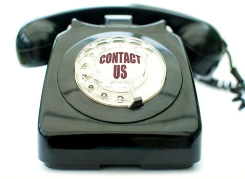 Vintage telephone over a white background