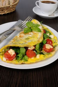 Omelet with spinach, basil, dill, cherry tomatoes and cheese Adyg

