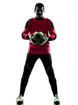 one caucasian soccer player goalkeeper man standing holding ball in silhouette isolated white background