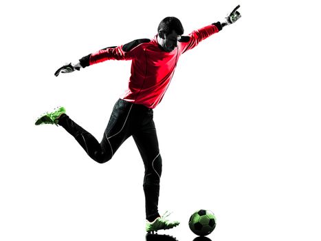 one caucasian soccer player goalkeeper man kicking ball in silhouette isolated white background