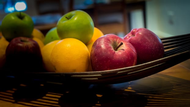 Fruit basket with ripe and delicious apples and oranges