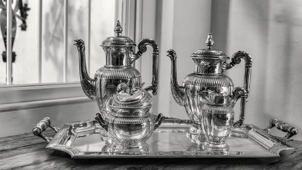 antique silver tea set with a two teapots, milk jug, sugar bowl, and a tray