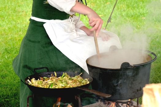 Medieval woman stirring pot