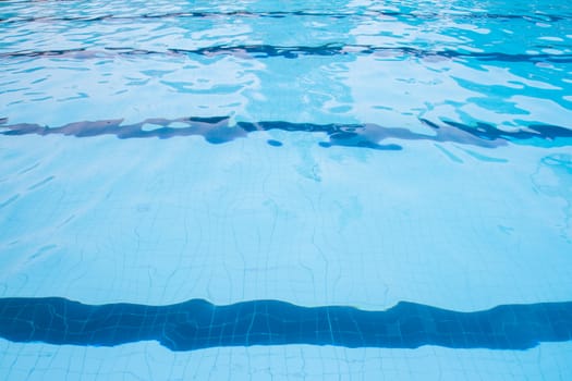 Swimming pool with blue water surface and swimming lanes