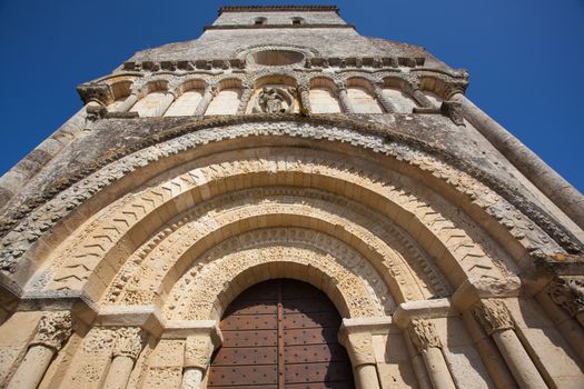 Main entrance archivolts detail of the Rioux church .Region of Charente in France