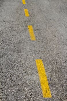 Closeup view of road lane markings on asphalt road
