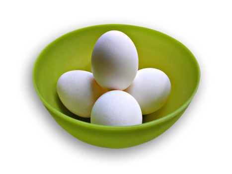 Chicken eggs in a green bowl isolated on a white background.