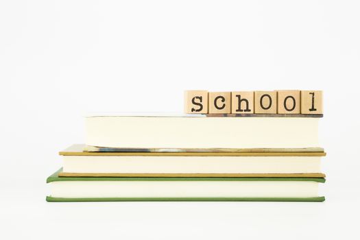 school word on wood stamps stack on books