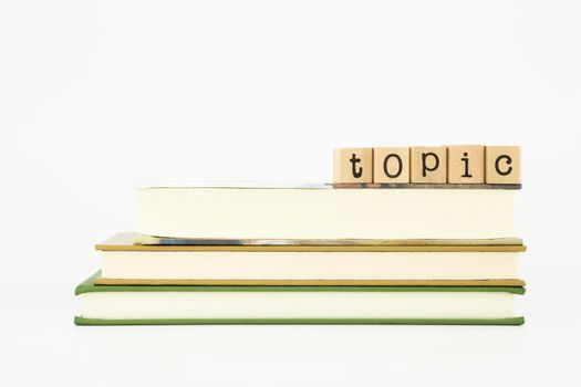 topic word on wood stamps stack on books