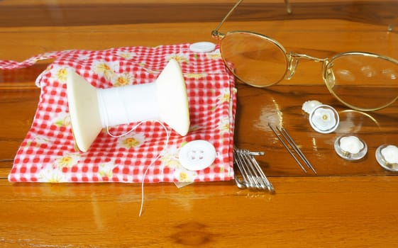 Sewing needles Including , thread, buttons, brooches and wear glasses to see clearly.                               