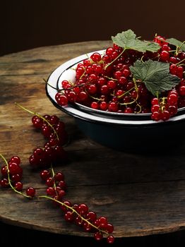fresh ripe red currant bowl on the wooden table
