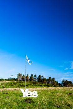 EDINBURGH, SCOTLAND - June 6, 2014: Scottish flag and the word YES referring to the referendum that will take place on the 18th September 2014 on whether Scotland should be an independent country as seen on June 6, 2014 on the Isle of Skye, Scotland, United Kingdom.