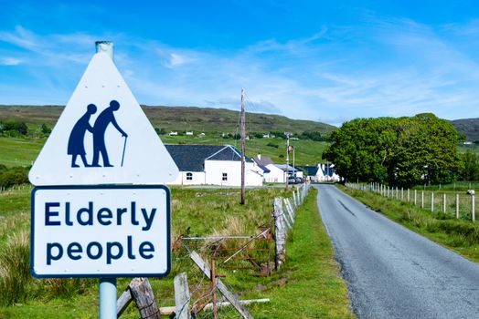 traffic sign for paying attention for elderly people at the entrance of a small Scottish village