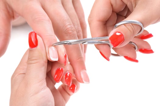 beauty salon, manicure applying, cutting the cuticle with scissors