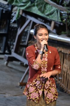 bandung, indonesia-june 16, 2014: beautiful lady as master of ceremony in saung angklung udjo choir.