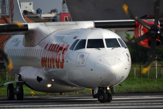 bandung, indonesia-june 16, 2014: Wings Air airplane taking manoeuvre on husein sastranegara airport bandung.