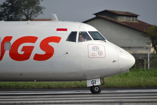bandung, indonesia-june 16, 2014: Wings Air airplane taking manoeuvre on husein sastranegara airport bandung.