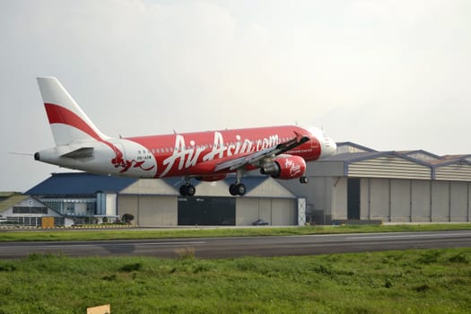 bandung, indonesia-june 16, 2014: Air Asia airplane taking manoeuvre on husein sastranegara airport bandung.