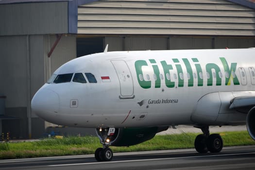 bandung, indonesia-june 16, 2014: Citilink airplane taking manoeuvre on husein sastranegara airport bandung.