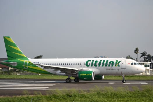 bandung, indonesia-june 16, 2014: Citilink airplane taking manoeuvre on husein sastranegara airport bandung.
