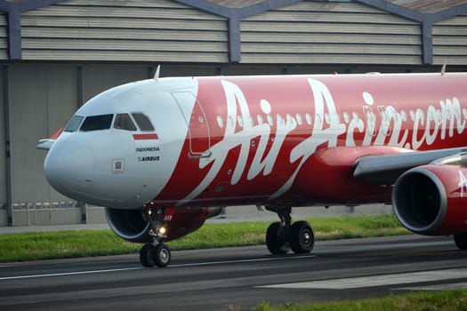 bandung, indonesia-june 16, 2014: Air Asia airplane taking manoeuvre on husein sastranegara airport bandung.